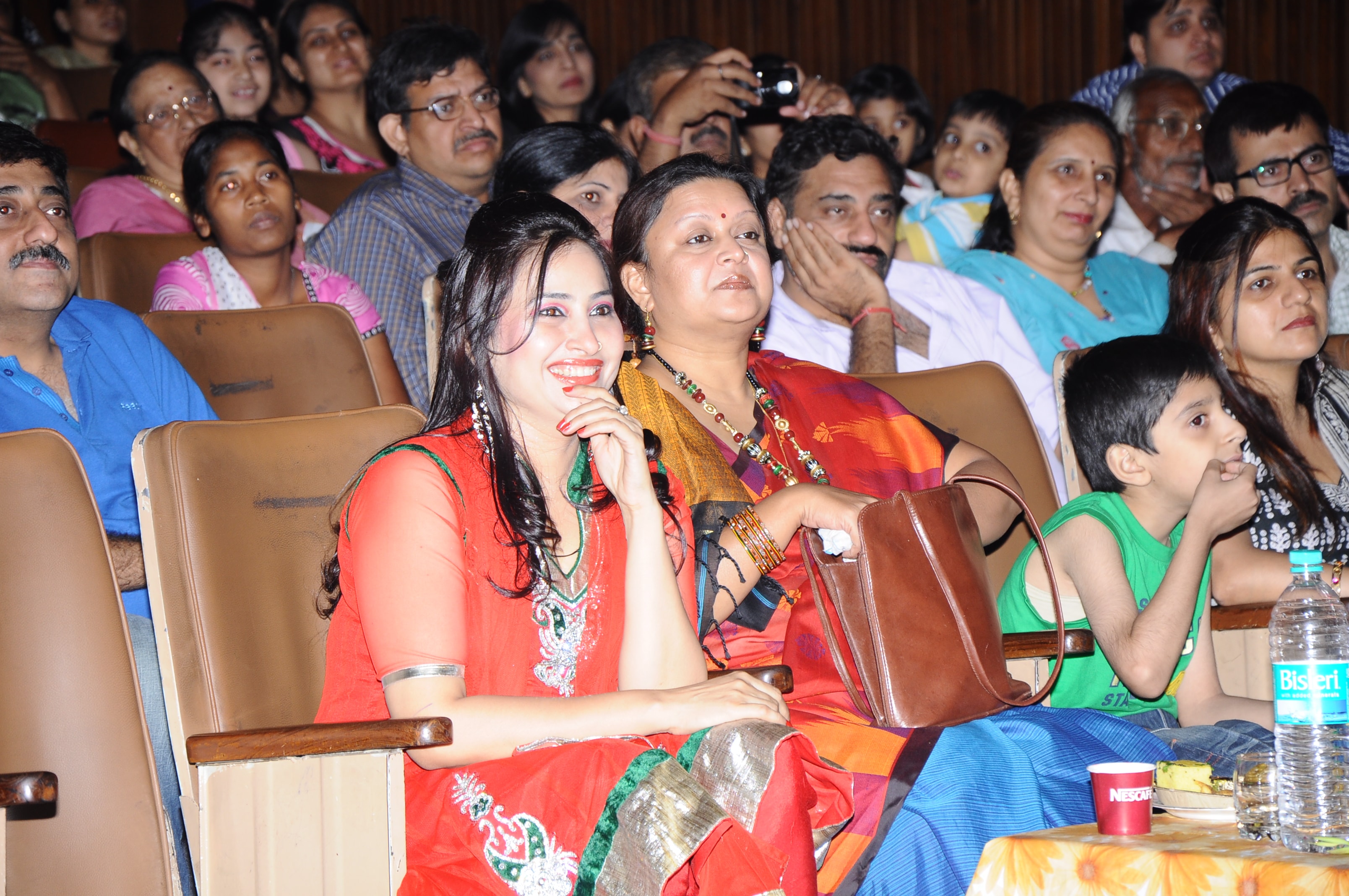 Group of students in colourful costumes performing Indian dance