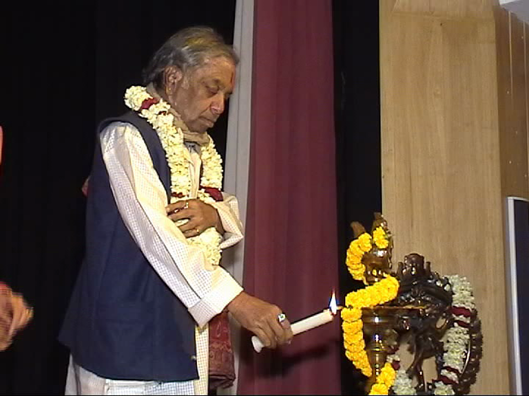Elder performing religious ceremony on stage